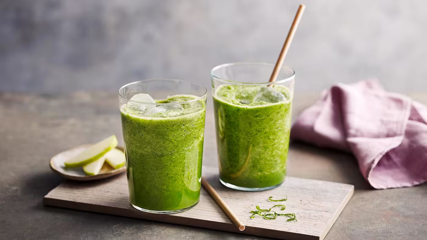 Fresh kale juice in glass with kale leaves